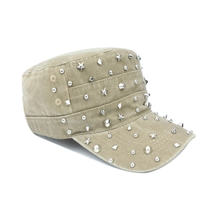 Detail of khaki military cap with silver metal studs and stars on washed cotton fabric