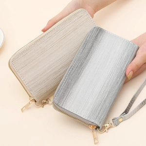 Detailed close-up of metallic brushed texture on gradient wallets with wrist straps