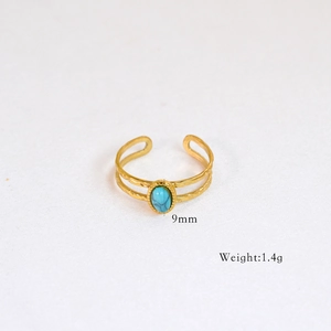 Detailed view of hammered 14k gold plated ring featuring an oval turquoise stone