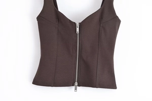 Detail of espresso brown slim fit zip-up vest featuring a central metallic zipper closure