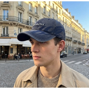 Detail of vintage washed baseball cap featuring 3D letter embroidery in urban street setting