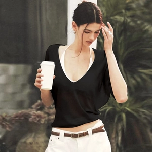 Detailed view of women's black V-neck sheer top with soft fabric texture and elegant drape