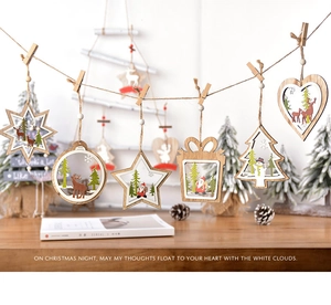 Detail of laser-cut wooden Christmas ornaments with hand-painted reindeer on a twine string