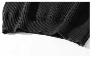 Detailed close-up of the thick ribbed knit texture on the black oversized hoodie sweater