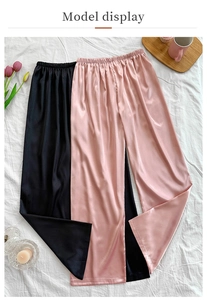 Close-up of lightweight satin wide-leg lounge pants with elastic waistband in black and pink