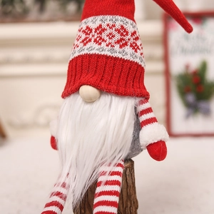 Macro view of Christmas gnome with knit hat and plush beard on a wood stump
