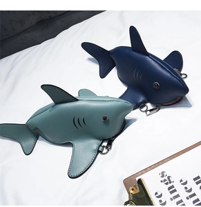 Detail of mini shark-shaped bags in mint green and dark blue with metal carabiners