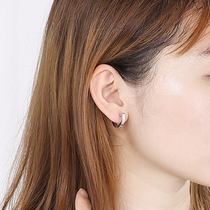 Minimalist U-shaped stainless steel hoop earrings in silver finish worn by a model