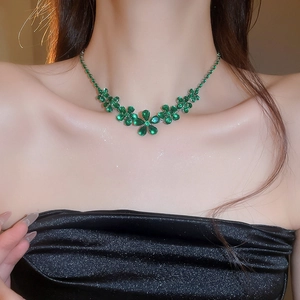 Macro view of green zircon flower pendant necklace on model with sparkling detail
