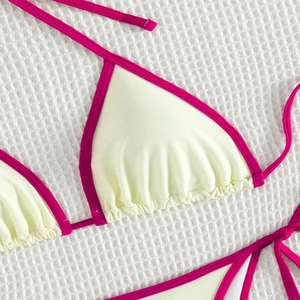 Detail of cream bikini top with hot pink contrast trim and ribbed waffle texture