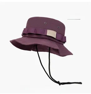 Detail of purple quick-dry sun hat showing breathable metal eyelets and adjustable chin cord