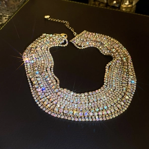 Sparkling multi-layer gold necklace with colorful crystals on a black background