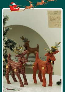 Detail of fabric Christmas reindeer with plaid patterns, ribbons and golden bells