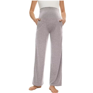 Detailed close-up of grey high-waisted maternity trousers with elastic belly support