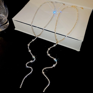 Detail of silver and gold rhinestone tassel necklaces with elegant Y-shaped drop chains