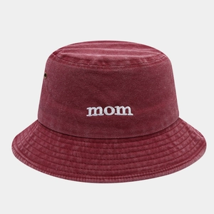 Macro detail of MOM embroidery and metal eyelets on washed cotton bucket hat