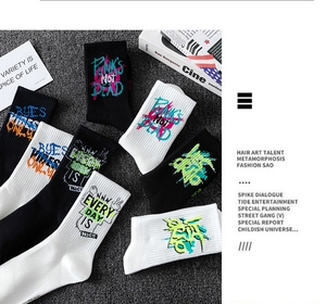 Close-up of cotton knit socks with fluorescent graffiti prints and punk quotes
