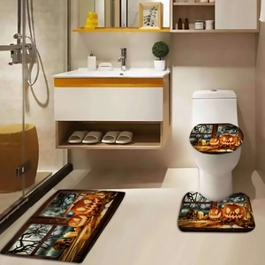 Three-piece Halloween bathroom mat set featuring glowing pumpkins and spooky skulls