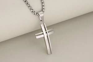 Detailed view of silver stainless steel hollow cross pendant with box chain