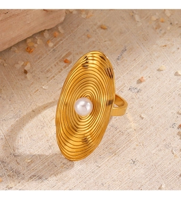Macro detail of golden geometric ring featuring textured ripple patterns and a centered pearl
