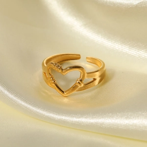 Minimalist gold heart-shaped open ring displayed on an elegant beige silk satin background