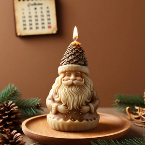 Glittery Santa Claus candle with pine cone hat on a rustic wooden tray with holiday decor