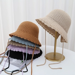 Knitted hollow sun hat for women with bow lace-up tie and scalloped rim design
