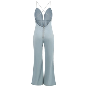Detail of cross rhinestone back straps on a light blue backless wide-leg jumpsuit