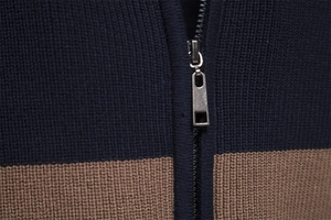 Close-up of contrast knit cardigan showing navy and brown texture with metal zipper