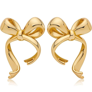 Polished minimalist bow-shaped gold ribbon stud earrings on a clean white background