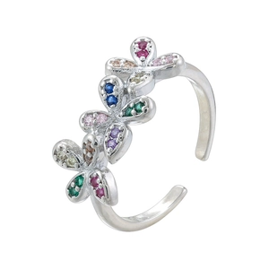 Macro shot of silver adjustable flower ring featuring colorful gemstones in a floral design