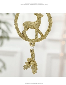 Detailed view of a golden glitter reindeer and holly leaf Christmas tree ornament