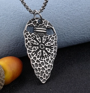 Close-up of a vintage silver Viking arrow pendant with Aegishjalmur symbol on box chain
