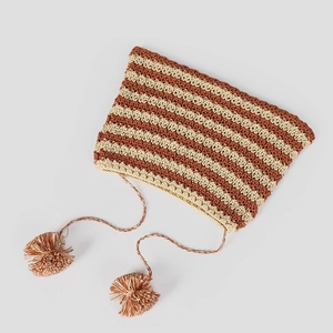 Detail of hand-knitted striped baby hat with cute cat ears and soft fluffy pompom ties