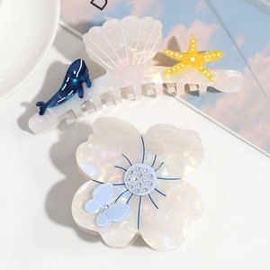 Floral and seashell pearl acetate hair claw clips with blue butterfly and dolphin motifs