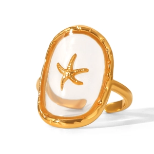 Macro detail of golden starfish ring with clear resin inlay and textured wave edge