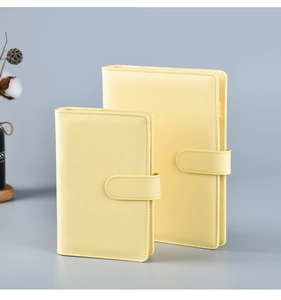 Detail view of two yellow PU leather notebooks in A5 and A6 sizes with buckle closure