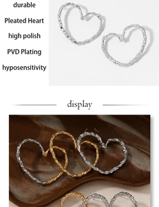Detailed view of heart-shaped earrings with pleated hammer texture and PVD gold plating