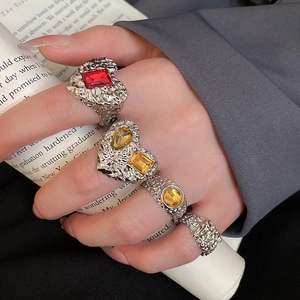 Detailed macro of textured silver resin rings with colorful gems and vintage lava finish