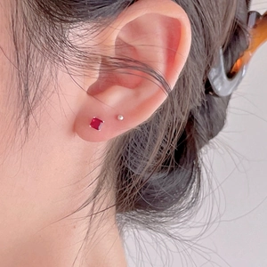 Minimalist 925 sterling silver stud earrings with red square zircon on model ear