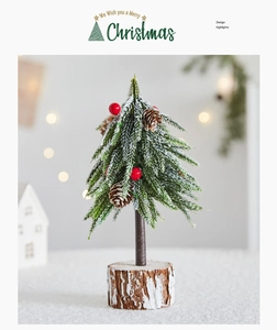 Close-up of mini snowy Christmas tree with red berries, pine cones, and a wooden base