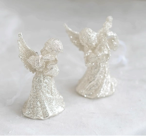 Close-up of sparkling silver glitter angel ornaments for Christmas tree decoration