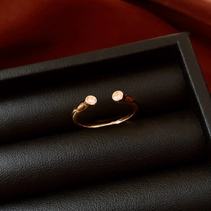 Detail showing an 18k gold plated open star ring set with tiny pink gemstones in a macro view