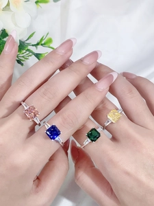 Close-up of four silver rings with colorful square-cut ice flower cubic zirconia stones