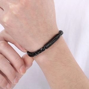 Close-up of black stainless steel woven chain bracelet worn on a male wrist