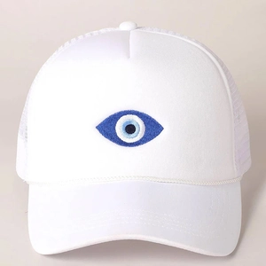 Detail shot of the evil eye embroidery and decorative rope on the white trucker hat
