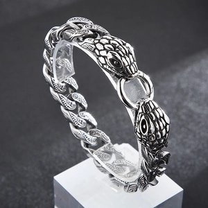 Detailed view of punk style double snake head Cuban chain bracelet with vintage silver finish