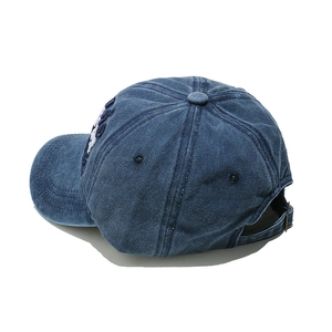 Detail view of washed navy cotton baseball cap with 3D embroidery and metal buckle