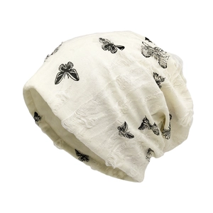 Chic butterfly print slouchy beanie with distressed ripped details in creamy white