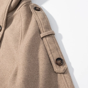 Close-up of camel wool coat shoulder with epaulets and detailed double stitching